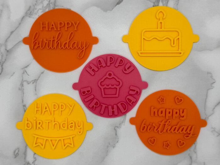 Five colourful birthday fondant stamps in a coordinated set